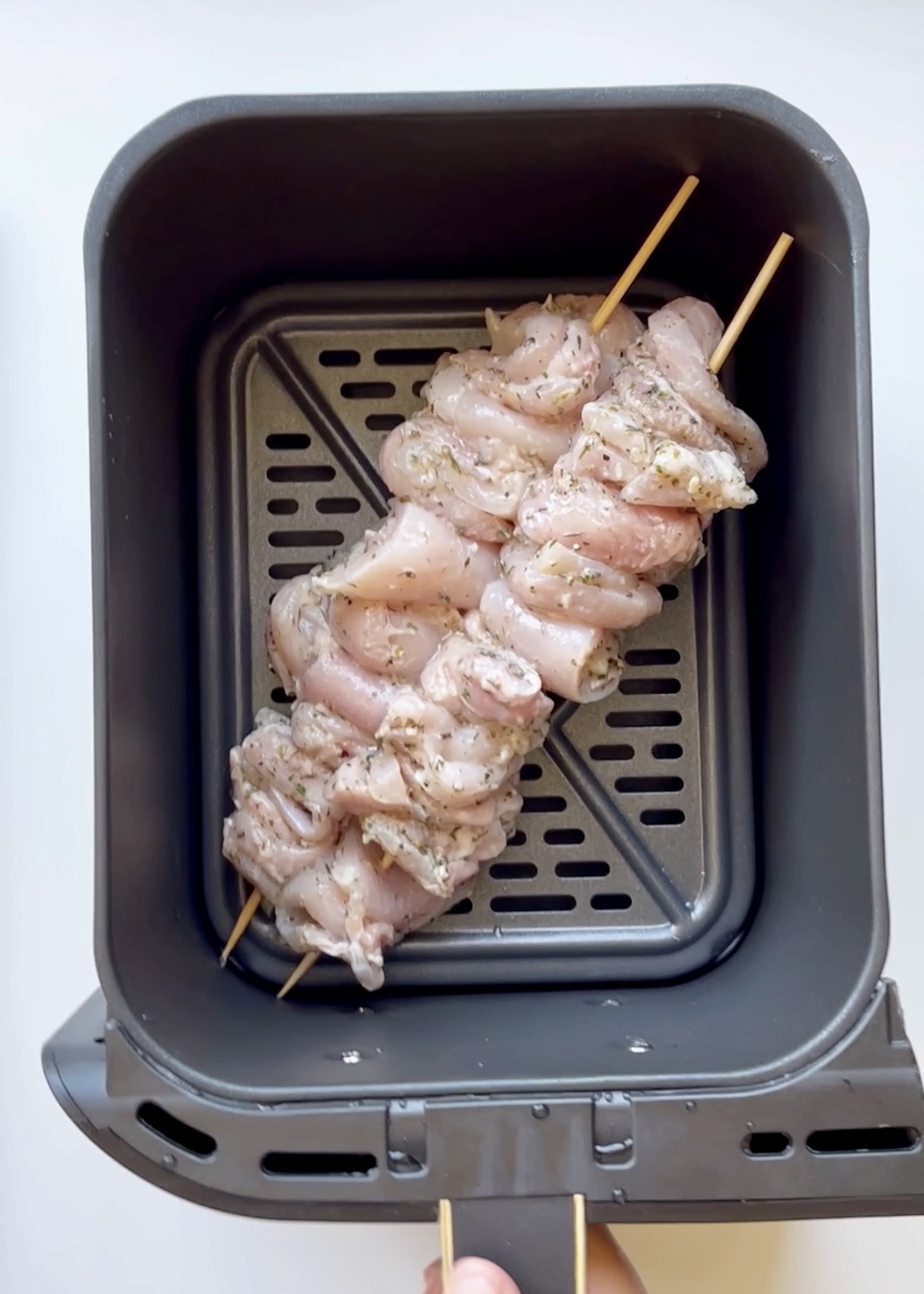 Chicken skewers in an air fryer.