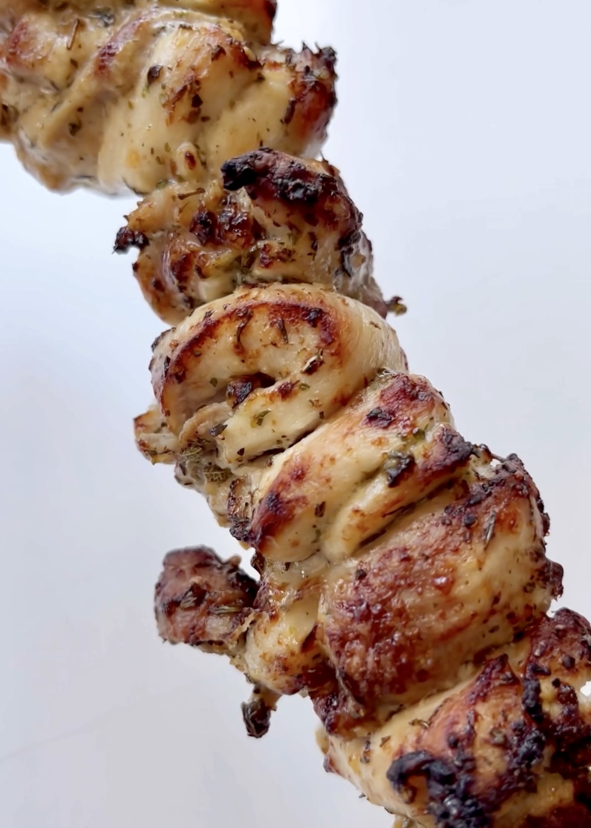 Crispy chicken gyros chicken on a skewer.