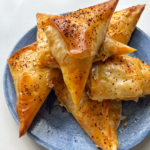 chilli oil feta pastries placed on a blue plate.
