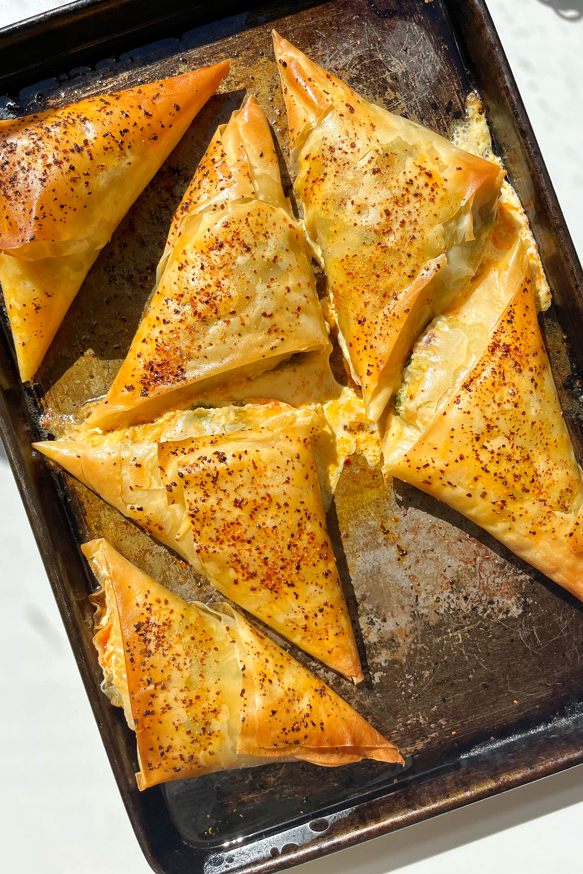 Feta pastries on a baking tray.