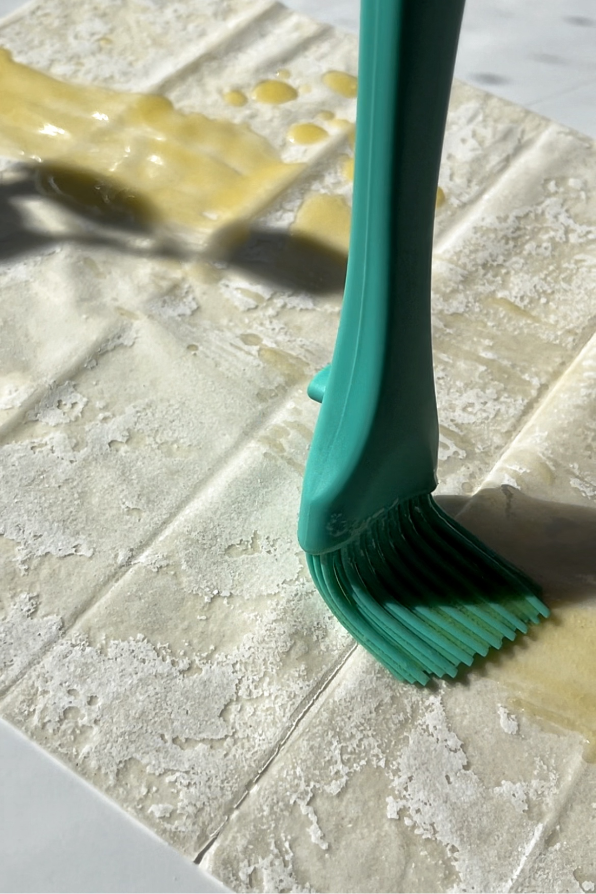 Brushing filo pastry with butter.