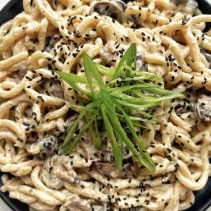 Creamy Udon recipe on a black plate
