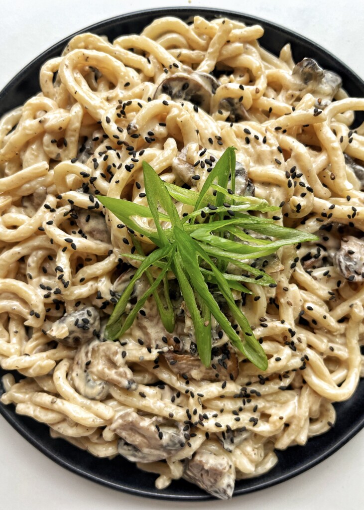 Creamy Udon recipe on a black plate