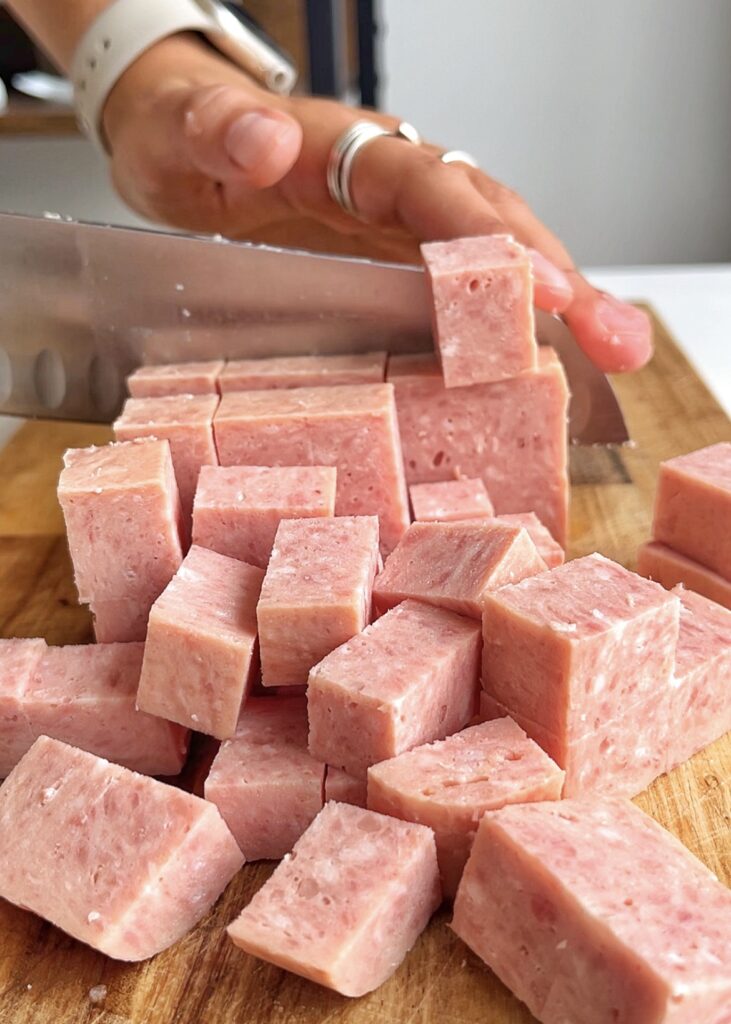Chopping up Spam on wooding chopping board