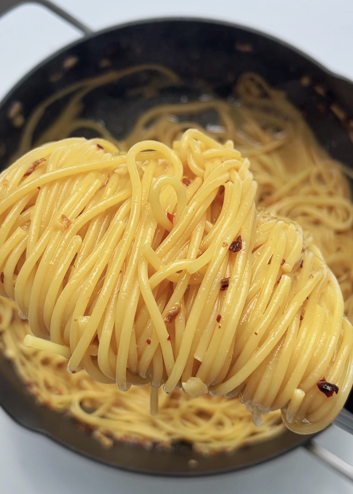 Tahini Chilli Oil Spaghetti being lifted from pan