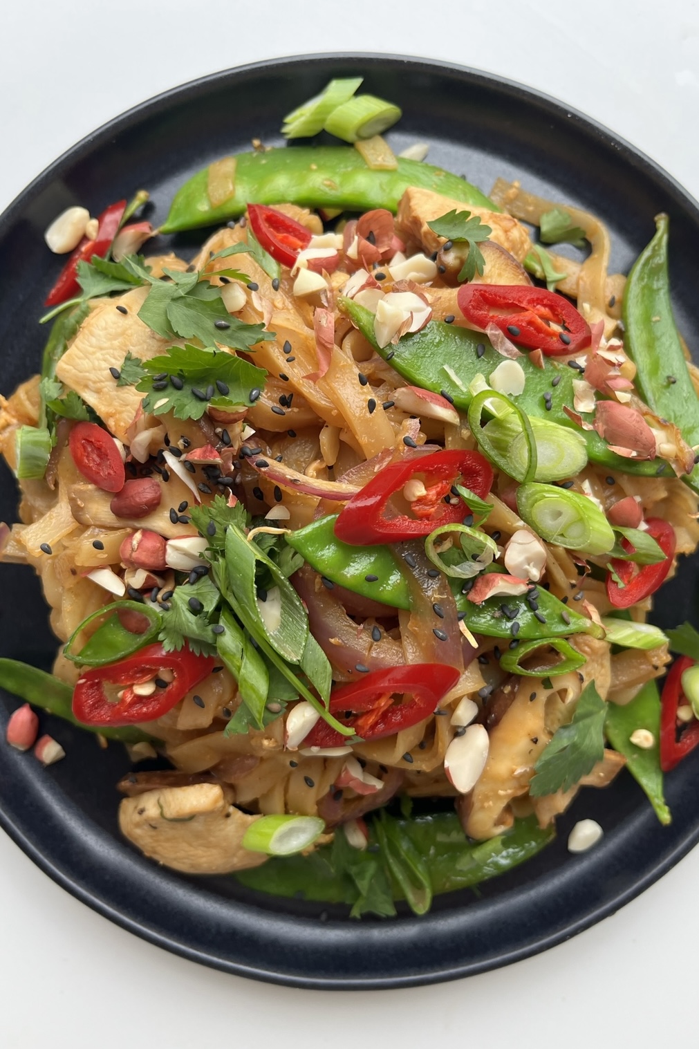 Wagamama pad Thai recipe on black plate.