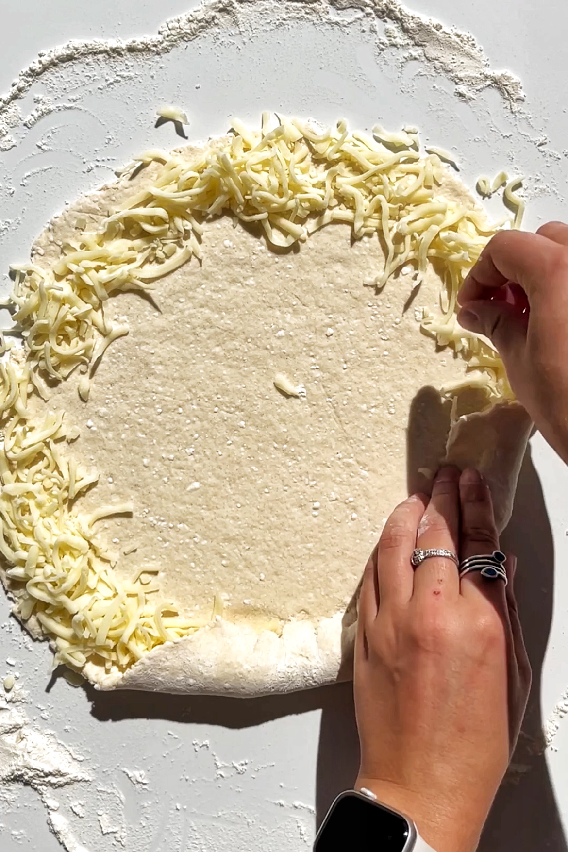 Homemade pizza dough with a mozzarella cheese crust.