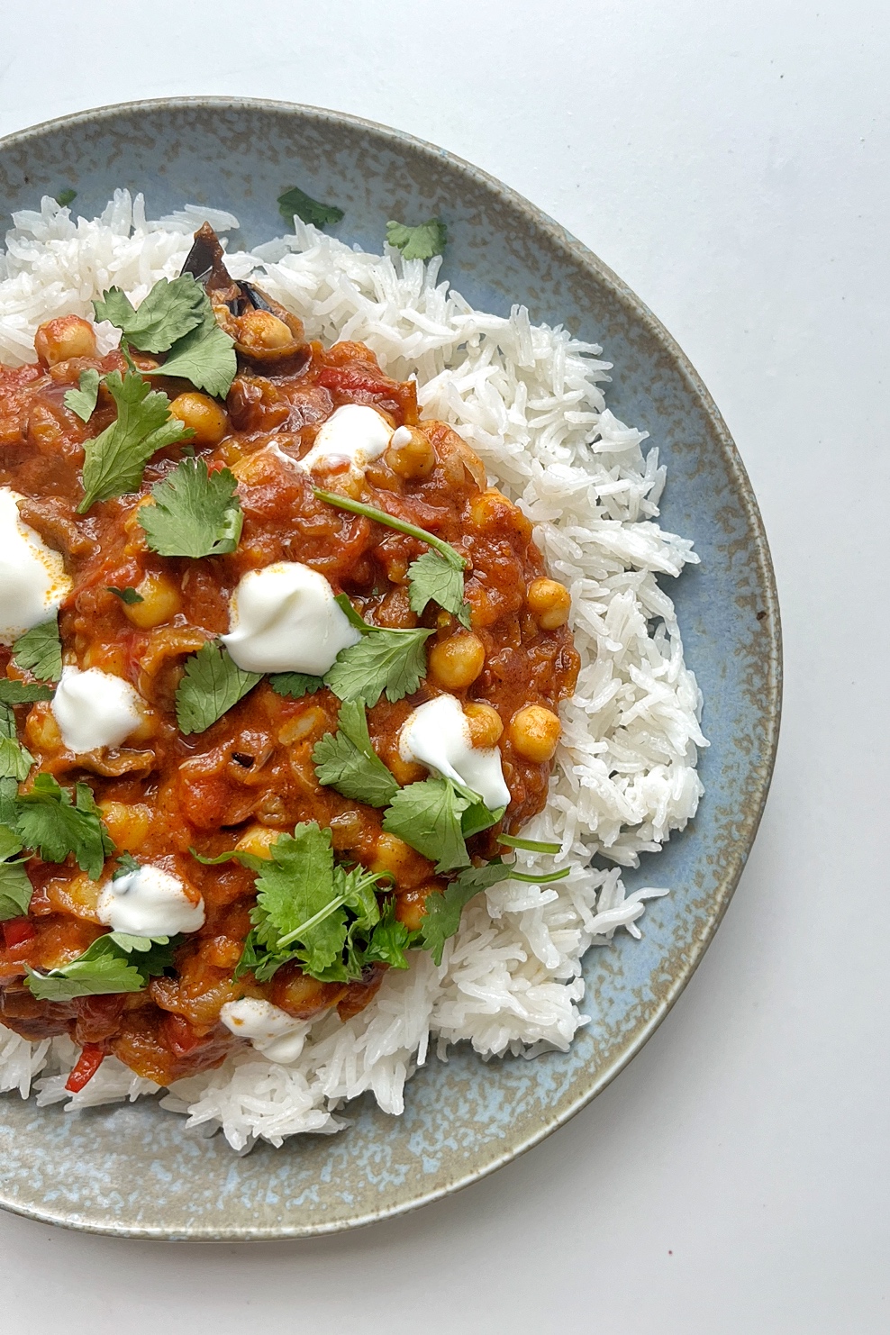 Half picture of aubergine tikka masala.