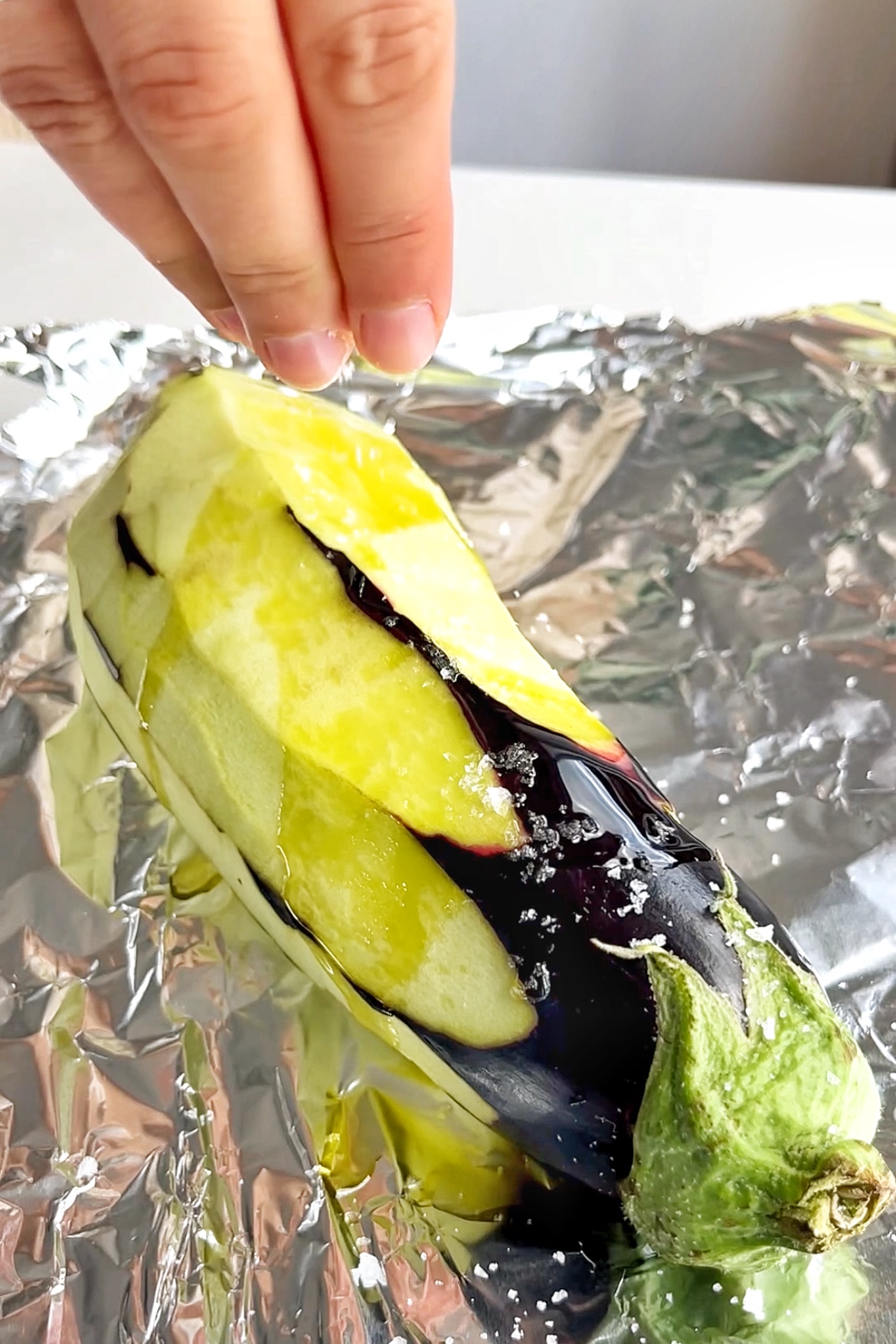 Air frying aubergine that is peeled.