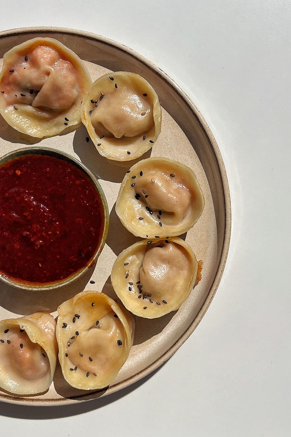 Half a picture of a plate of dumplings, Korean Mandu dumplings.