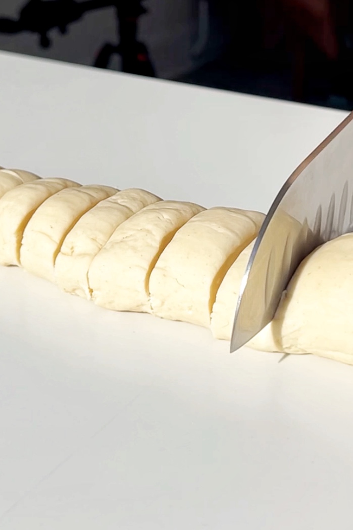 Slicing dumpling dough.