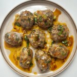 Steamed rice paper dumplings on cream plate.