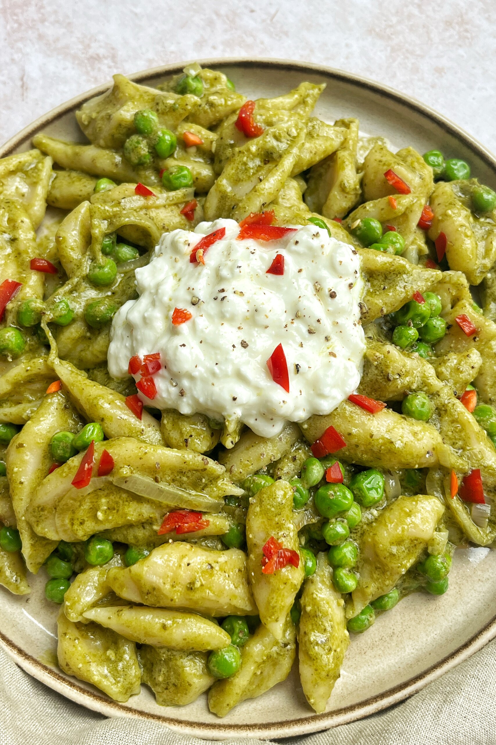 Close up of scissor cut tofu pasta in a pesto sauce.