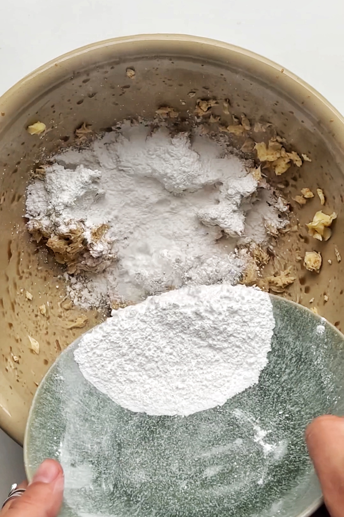 Adding icing sugar into a butter mix.