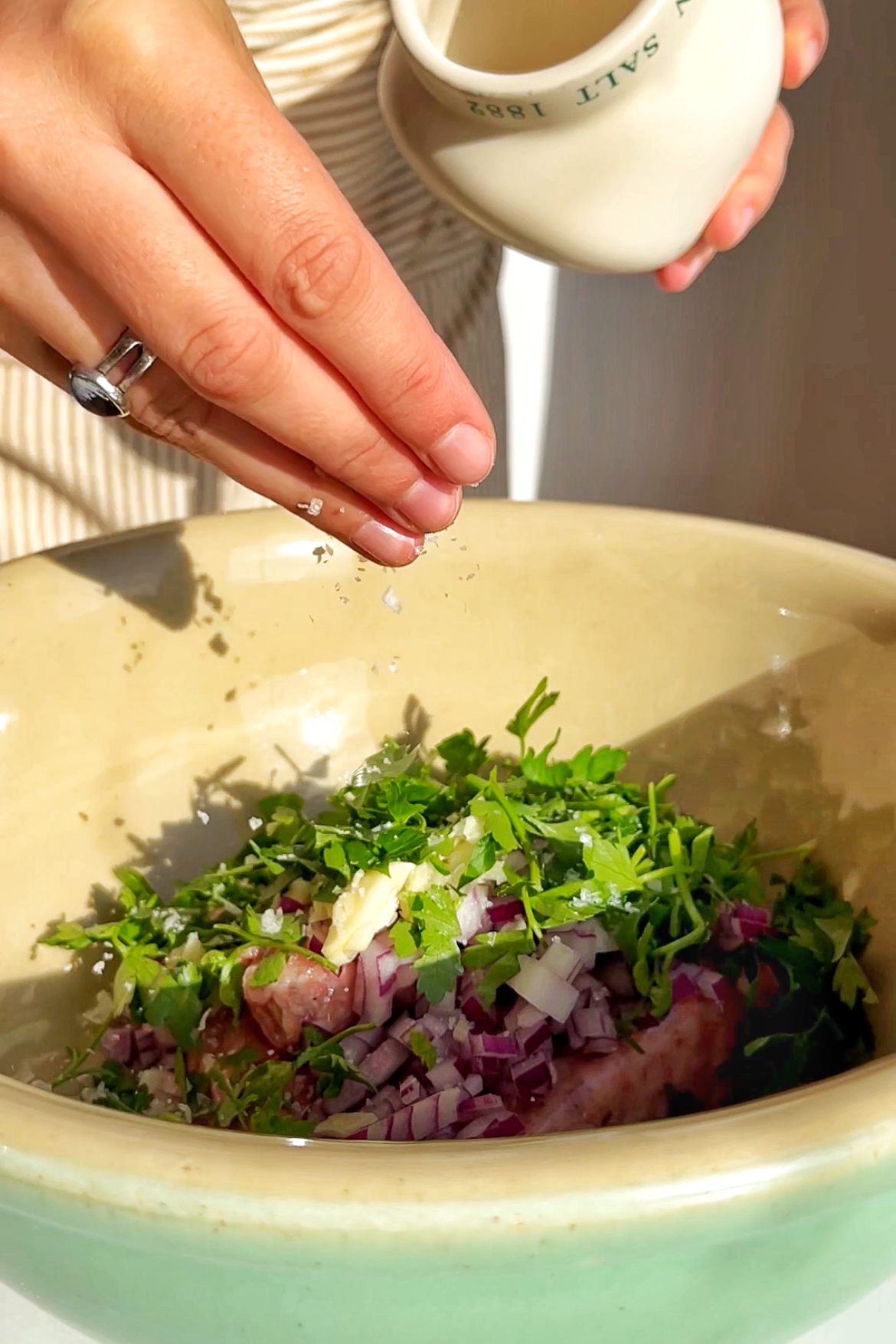 Making the filling for honey harissa sausage dumplings.