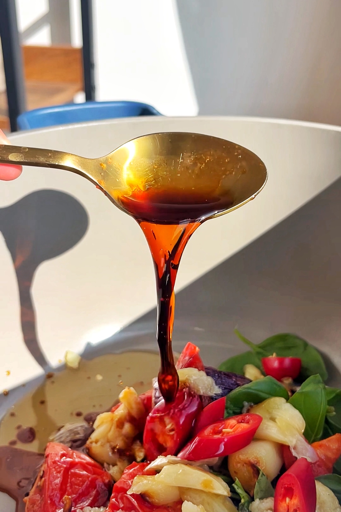 Adding seasonings into a tofu and tomato soup.