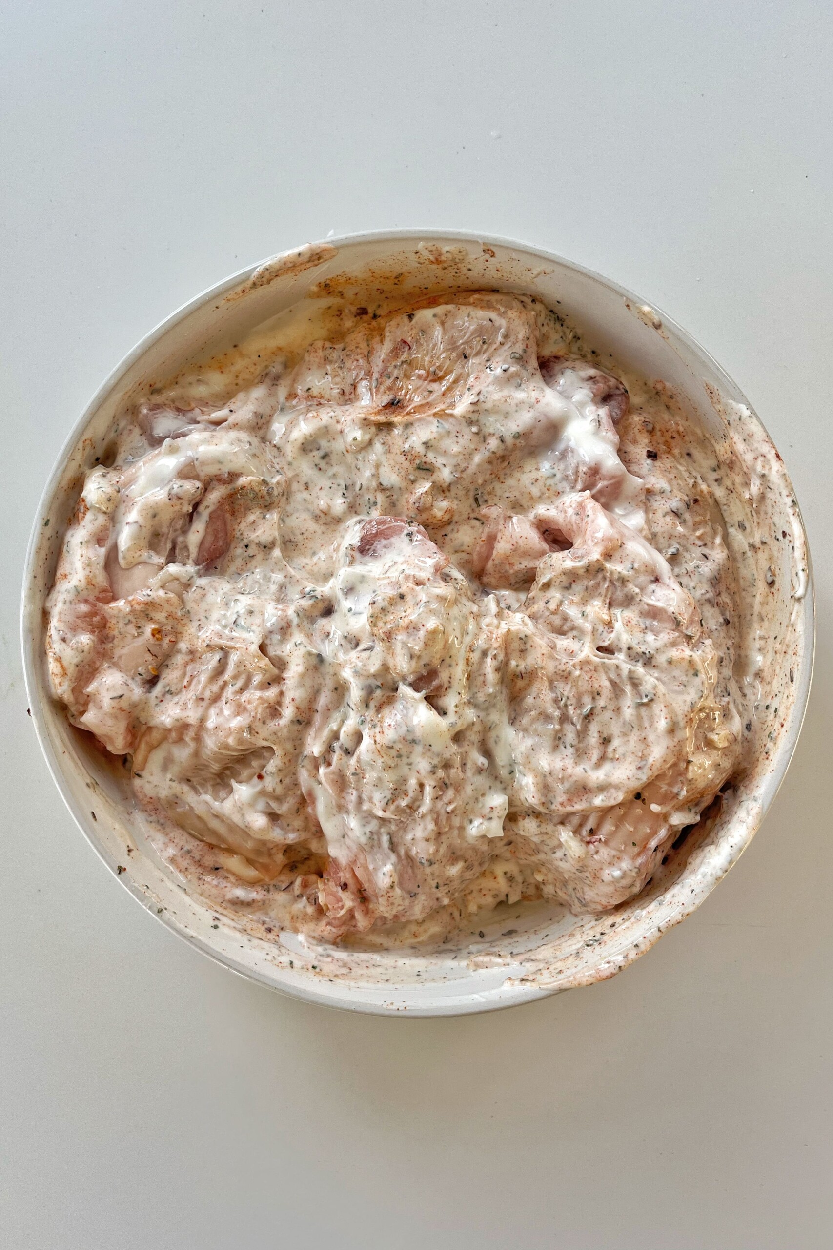 Mixed marinated chicken in a bowl.