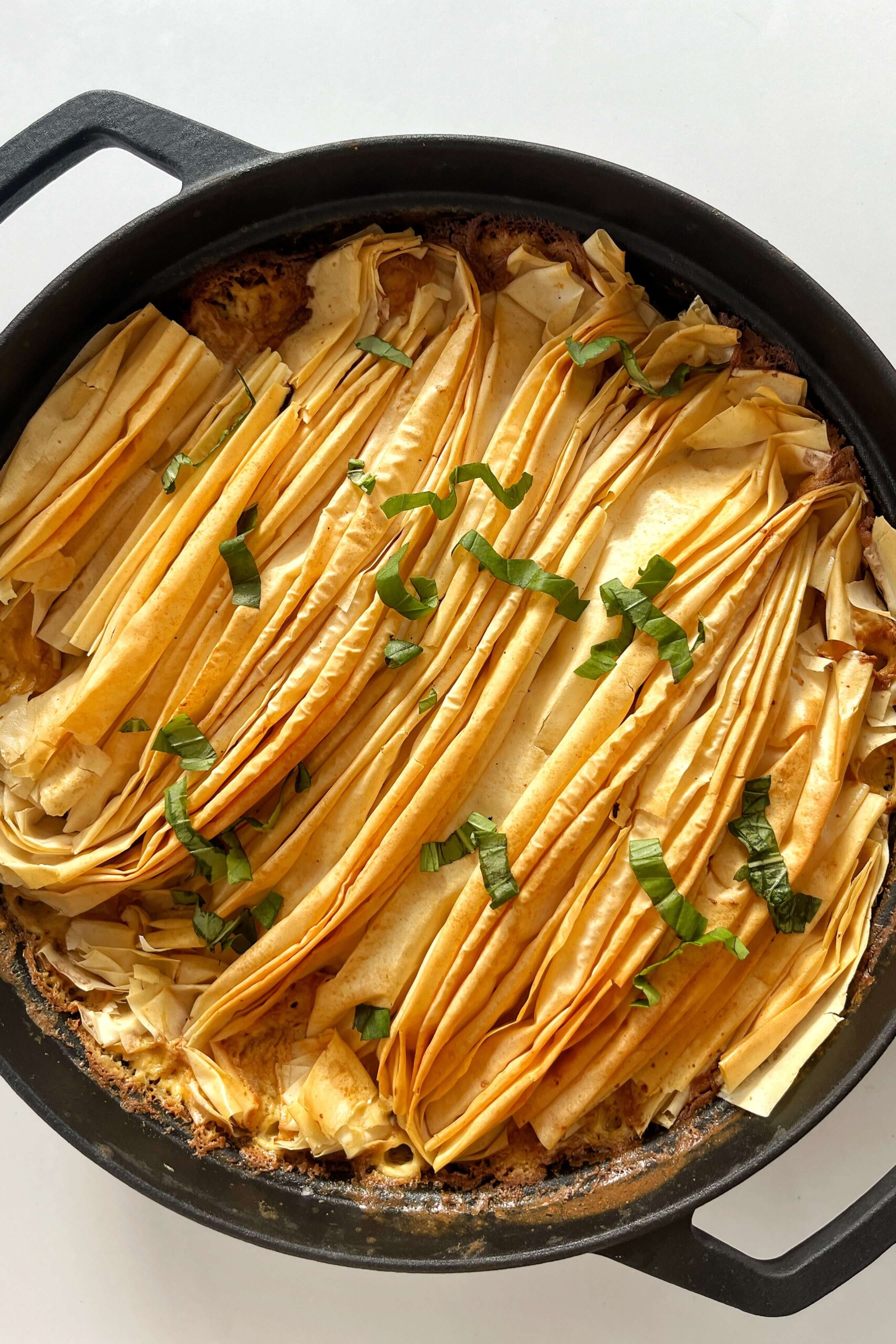 Black pan with a crispy filo Boursin pie in it.