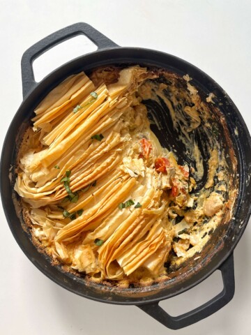 Boursin pie in a black pie with a spoonful taken out of the pie.