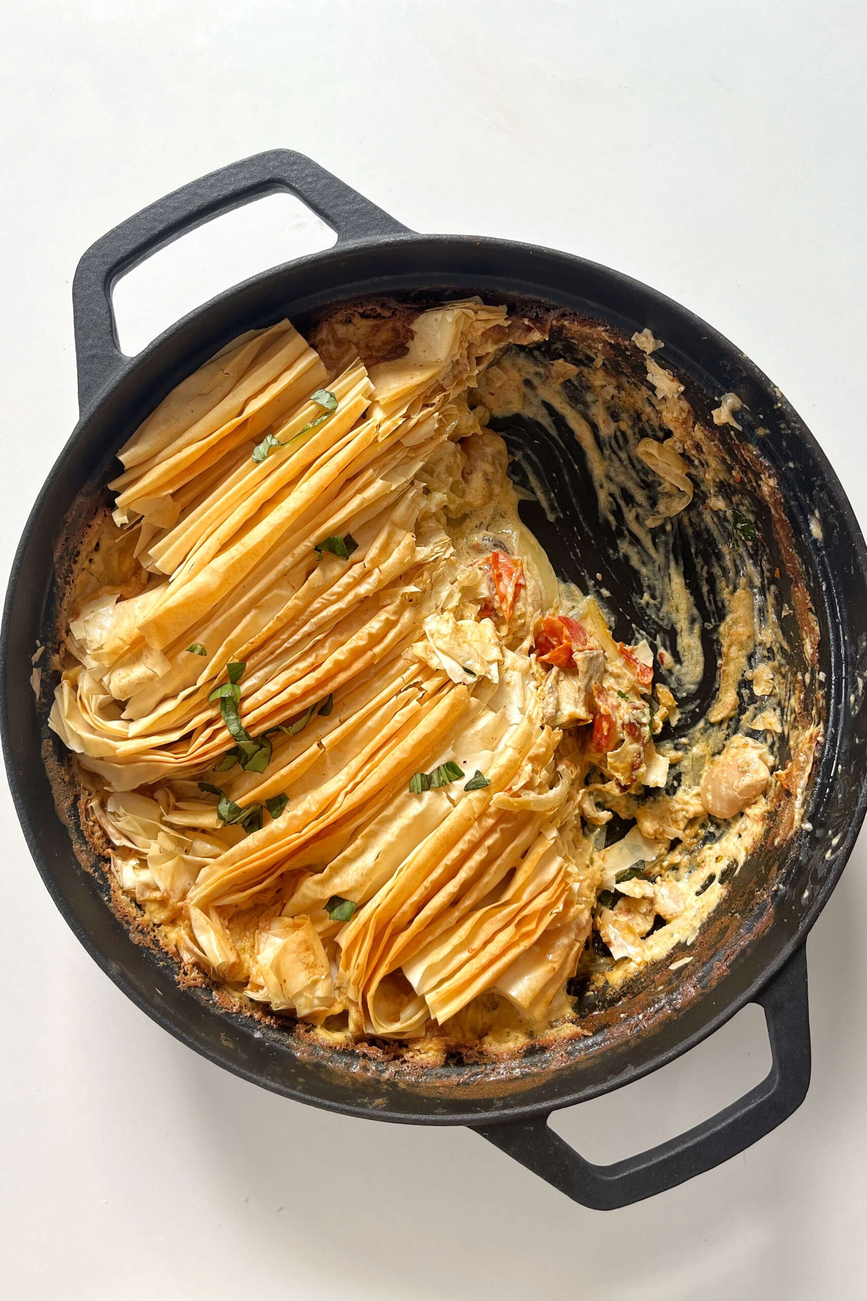 Boursin pie in a black pie with a spoonful taken out of the pie.