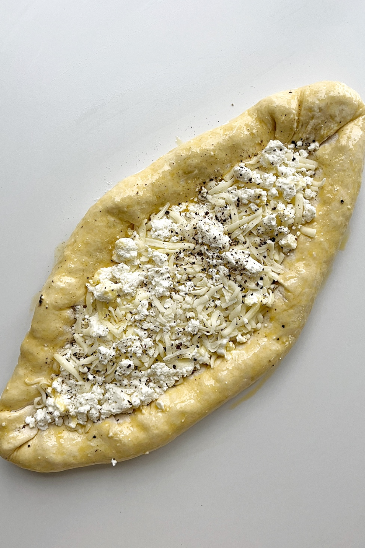 Cheese boat with cheesy stuffed crusts, uncooked.