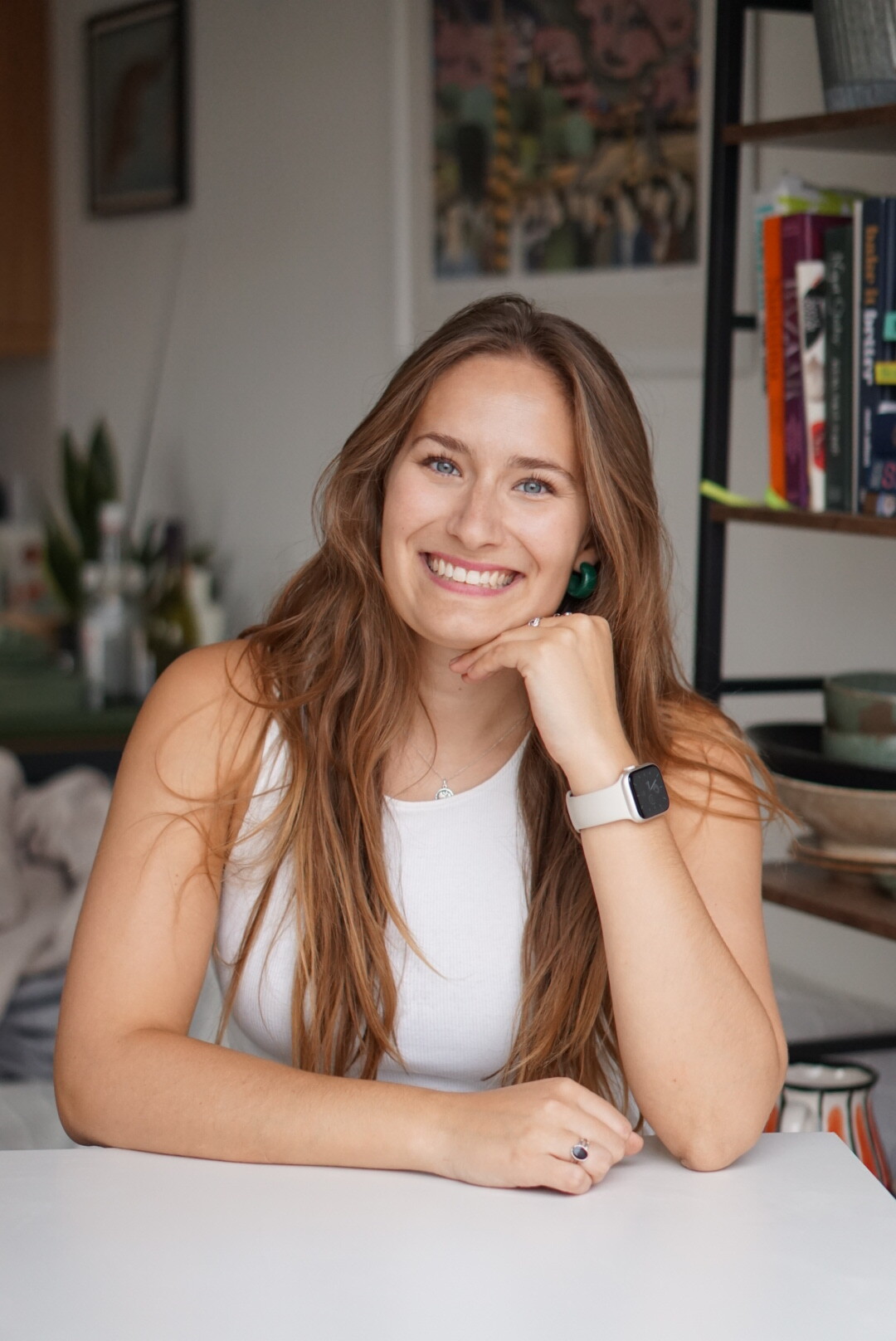 Emily Roz in white top smiling.