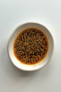 Dipping sauce in white bowl.