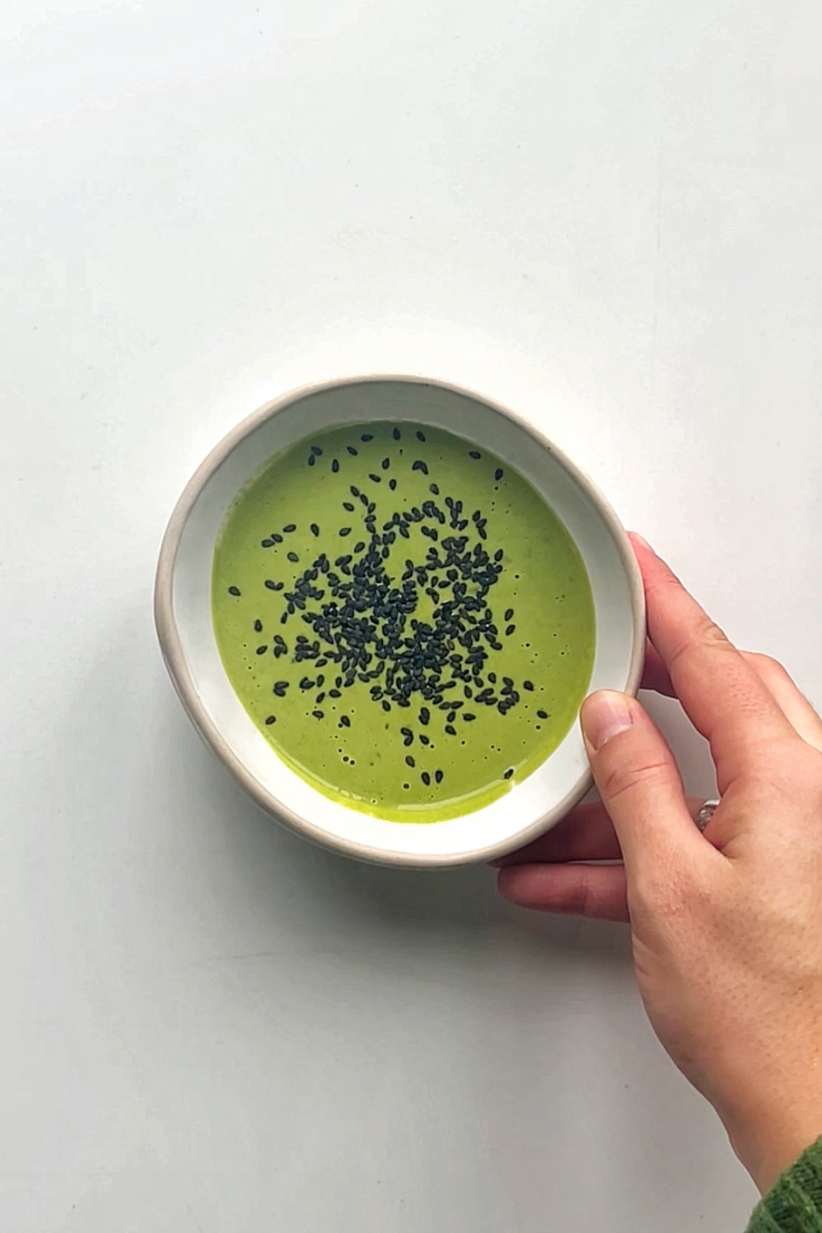 Bowl of green tahini sauce.