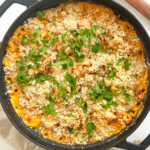 Black pan with a turkey Mac and cheese inside.