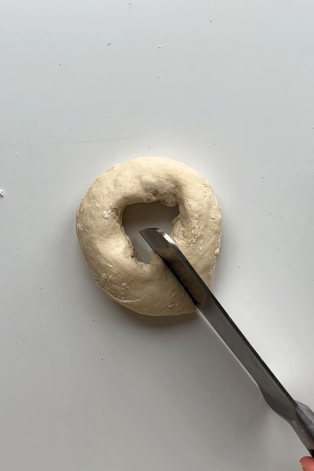 Slicing dough with a knife.