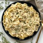 white ragu with tagliatelle on a white background.