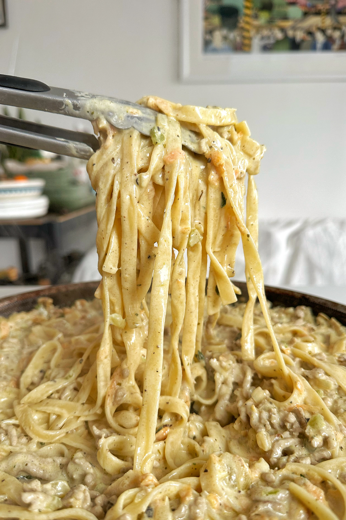 White ragu being pulled up by pincers.