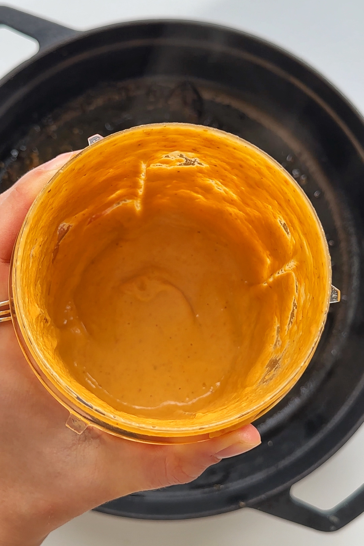 Blender with creamy tomato sauce inside.