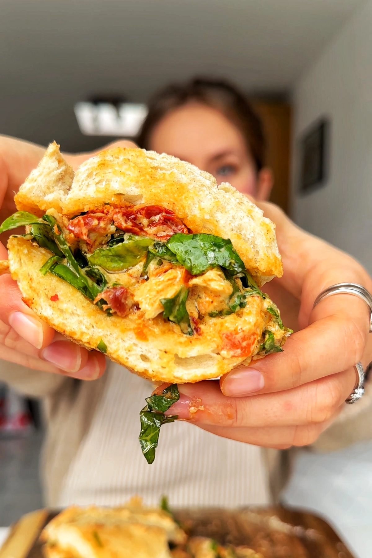 Close up of marry me chicken chopped salad sandwich.