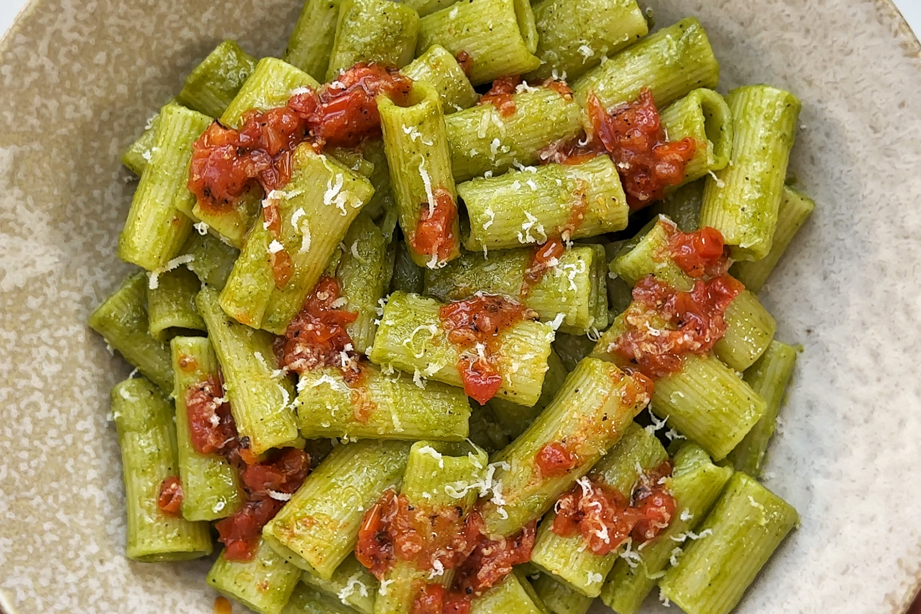 Cilantro pasta topped with a tomato paprika drizzle.