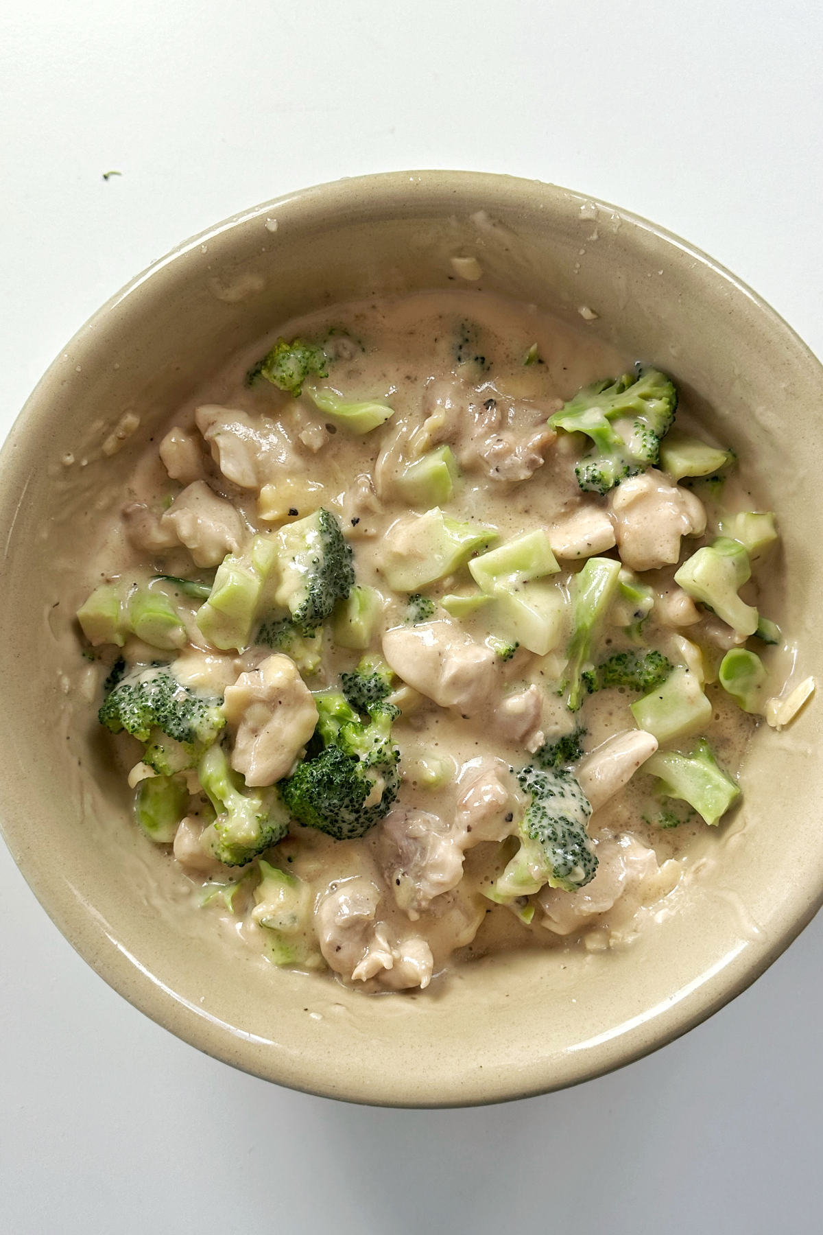 Mixture of broccoli, chicken, and cream of mushroom soup in a large bowl.