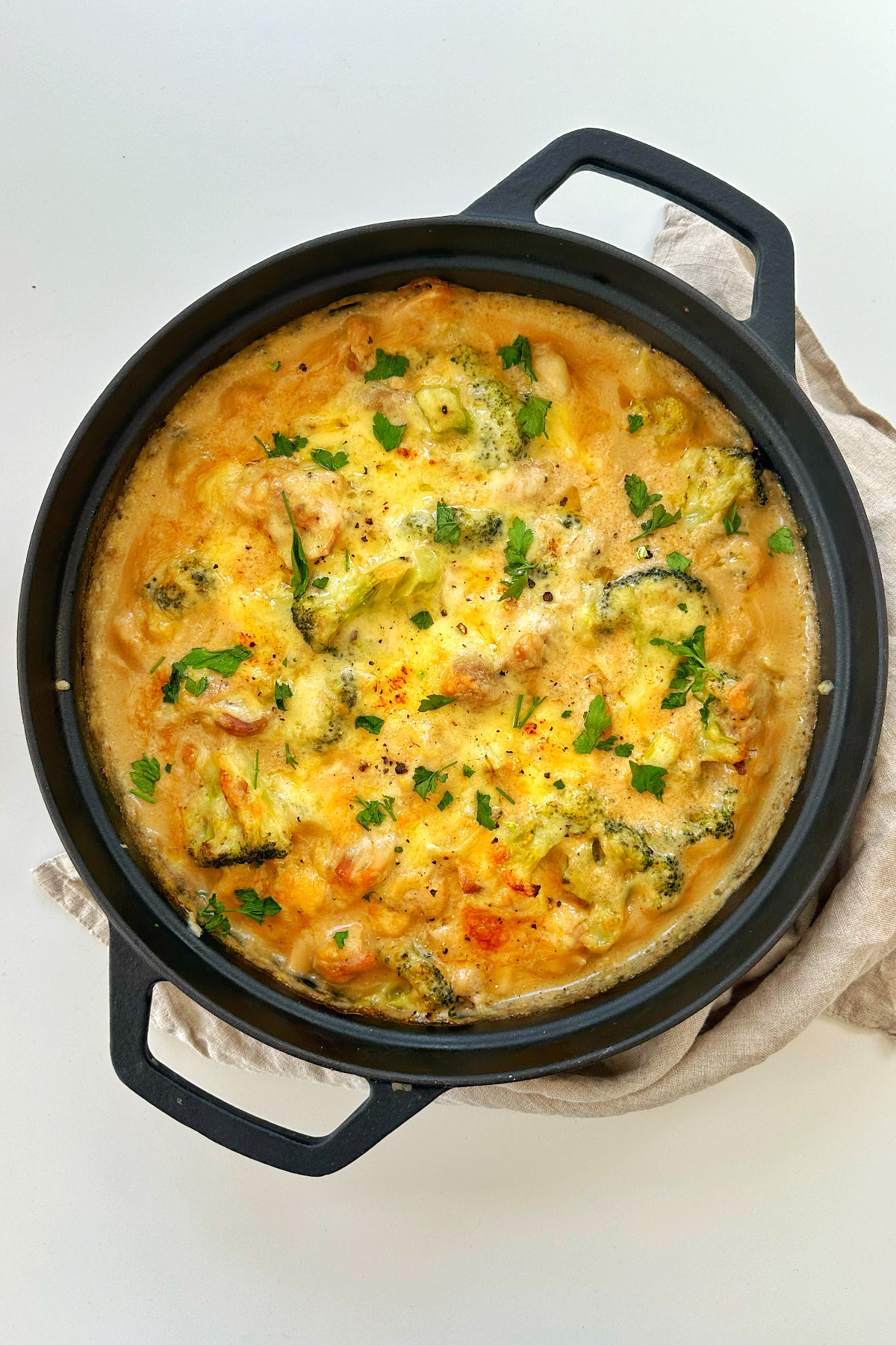 Cooked chicken casserole in a black dish.
