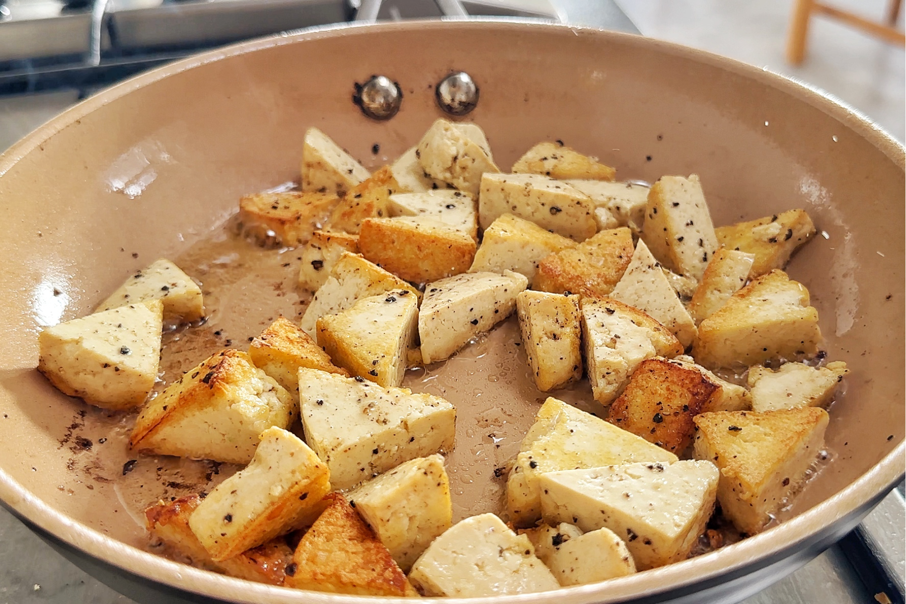 Frying tofu in a non-stick pan.