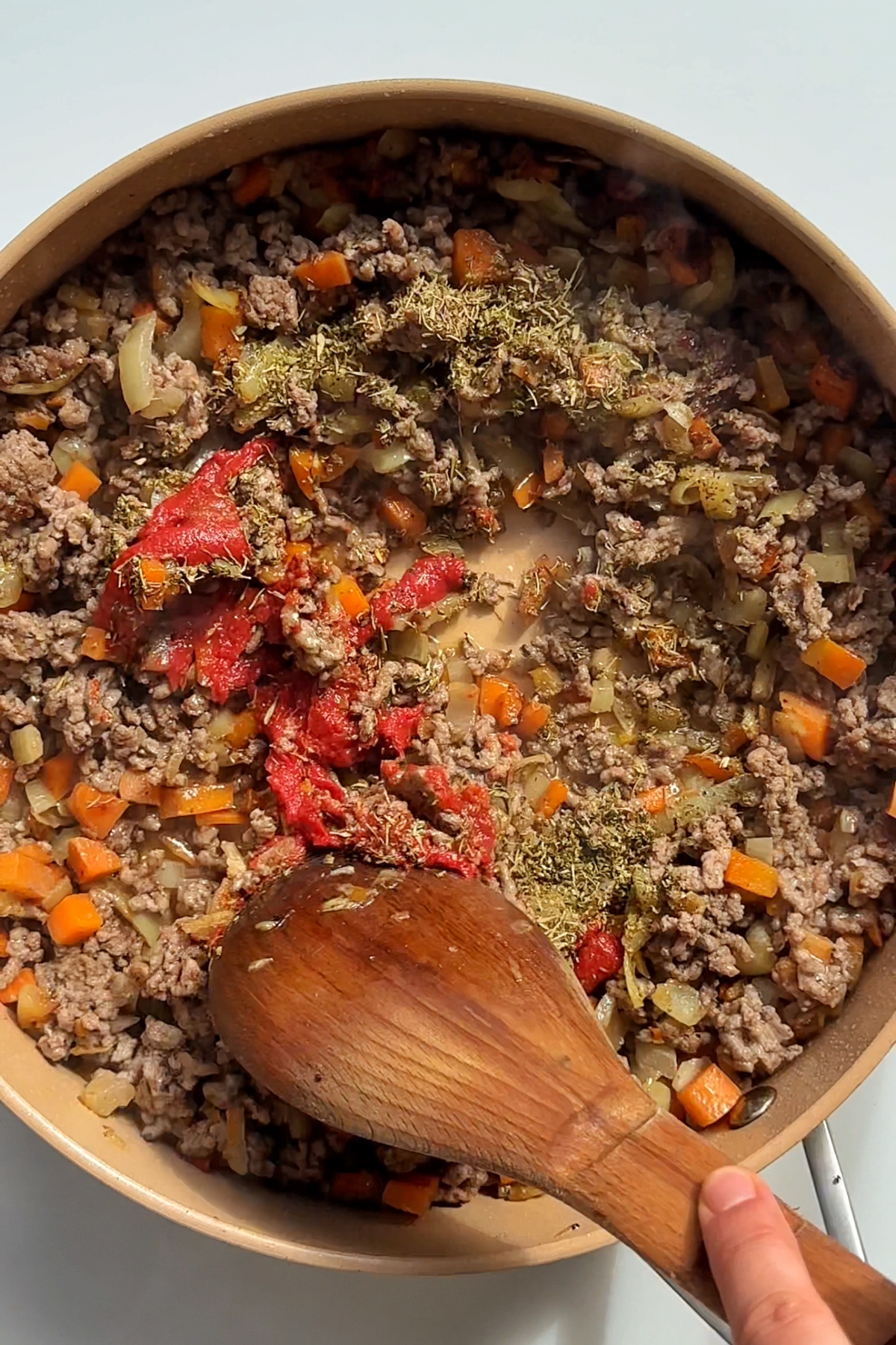 Frying carrots, onions, garlic, beef mince, and tomato puree.