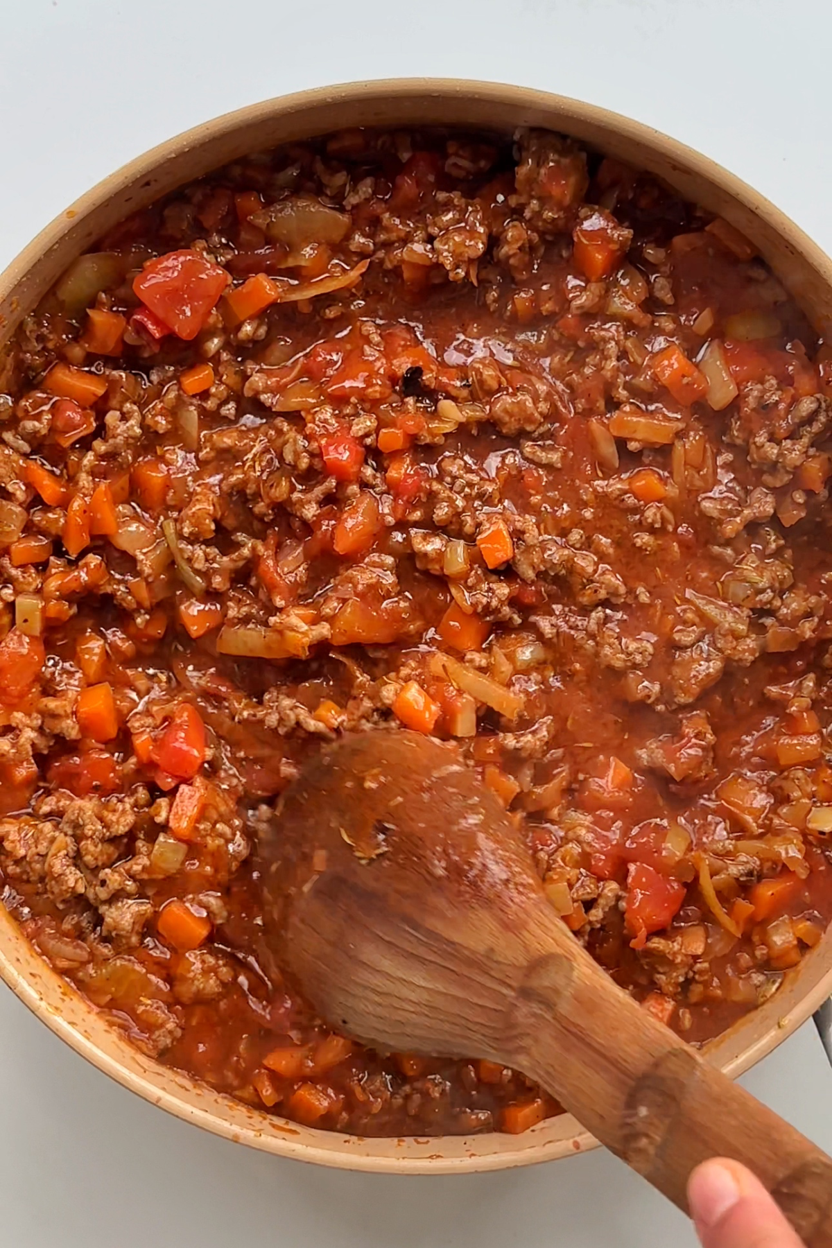 Cooking a bolognese in a pan.