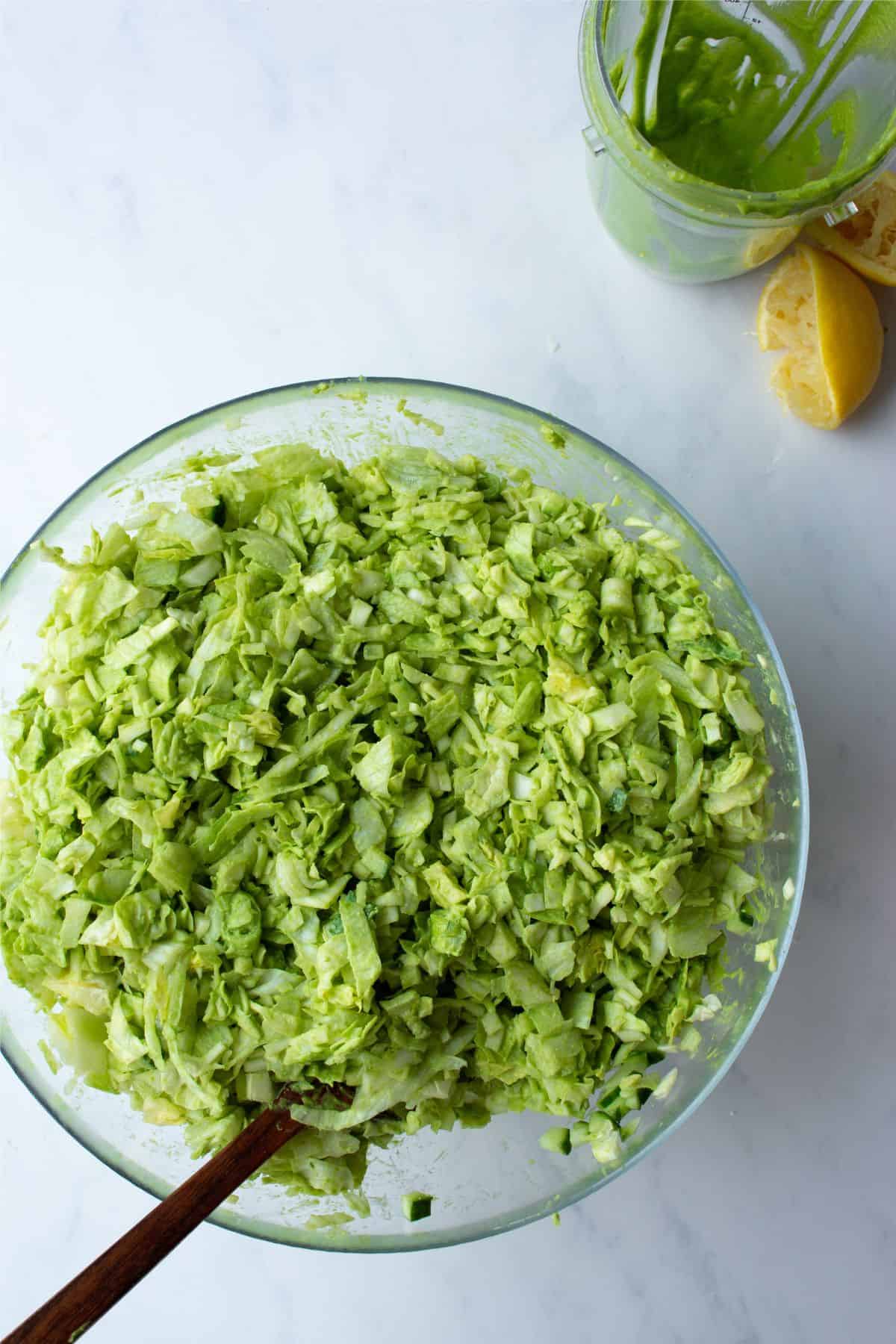 Green goddess salad in a glass bowl.