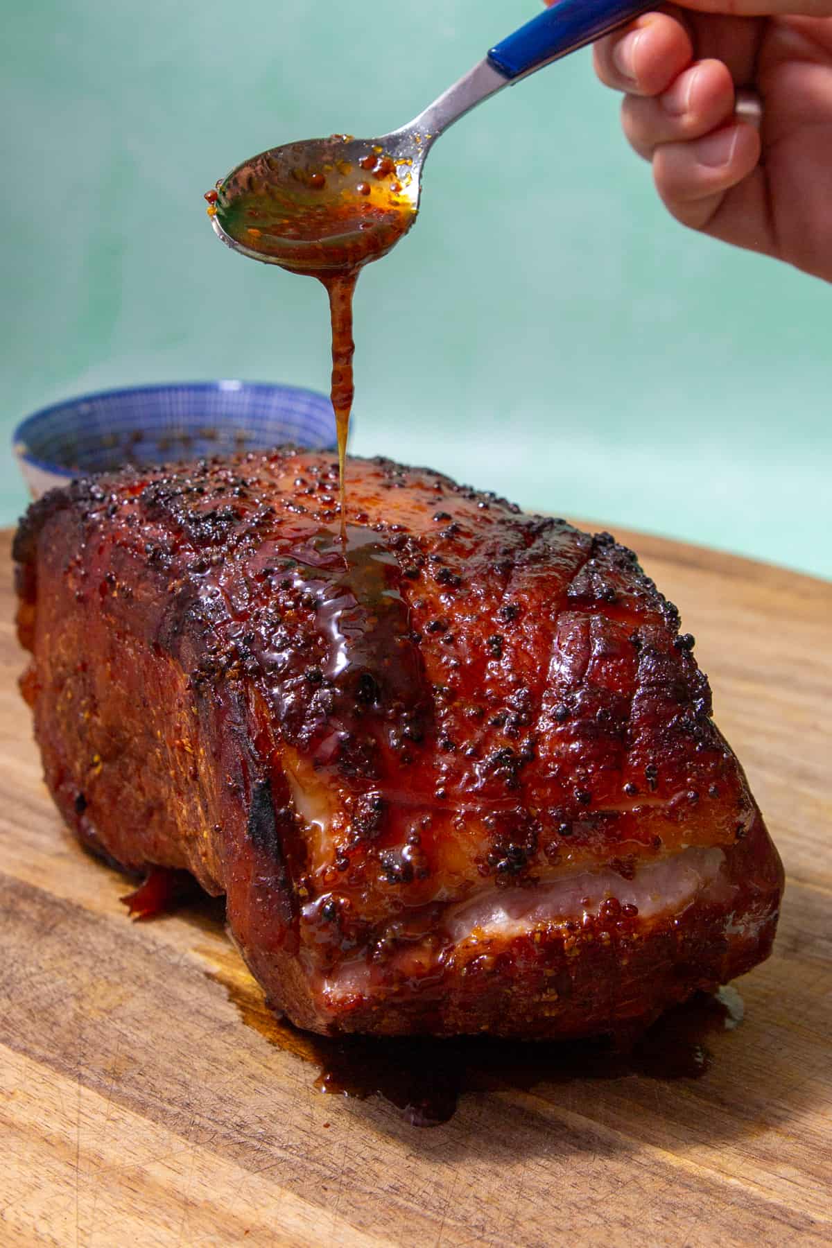 Pouring hot honey over ham.