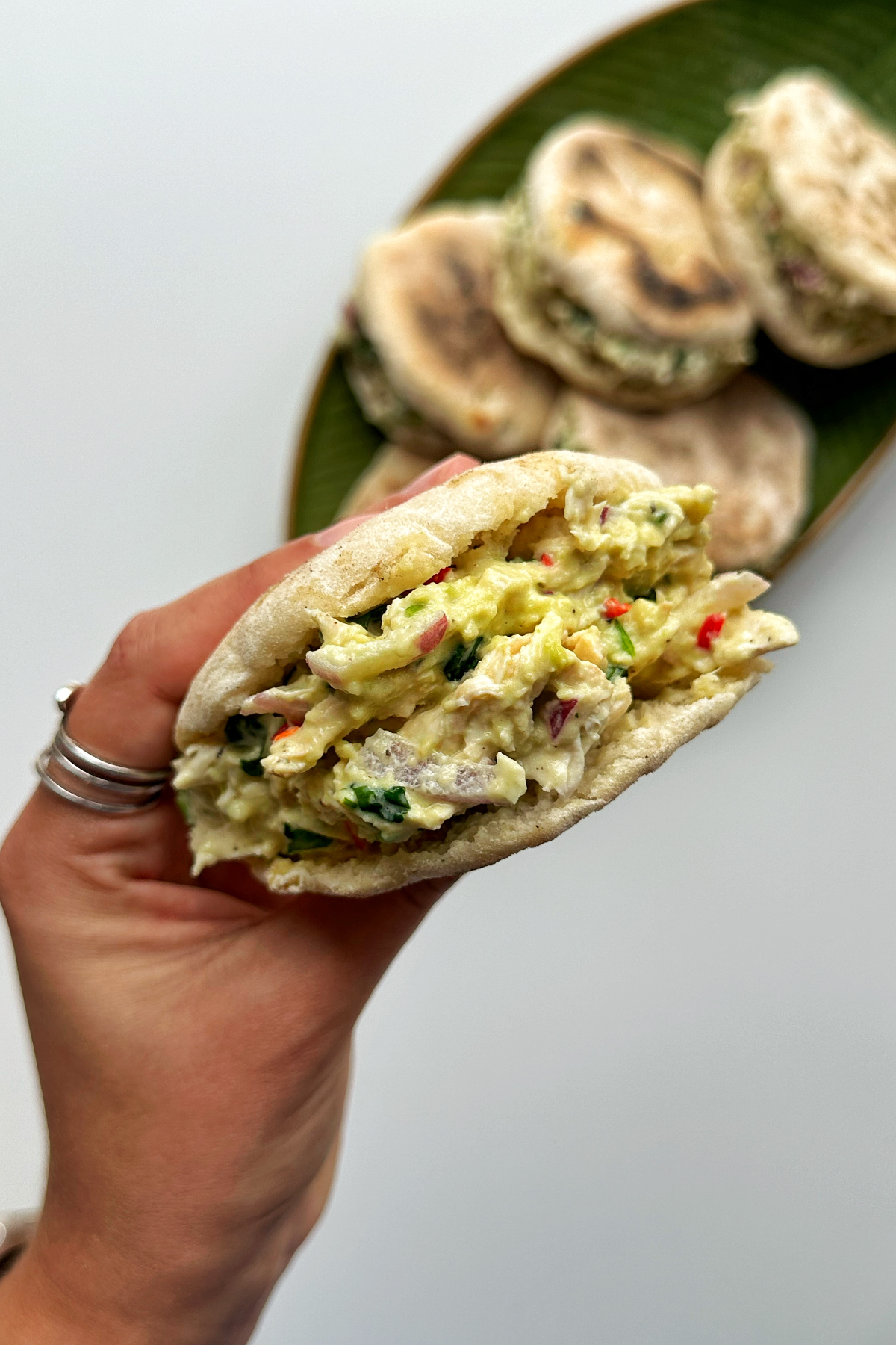 Holding up a cheat arepa with one hand.