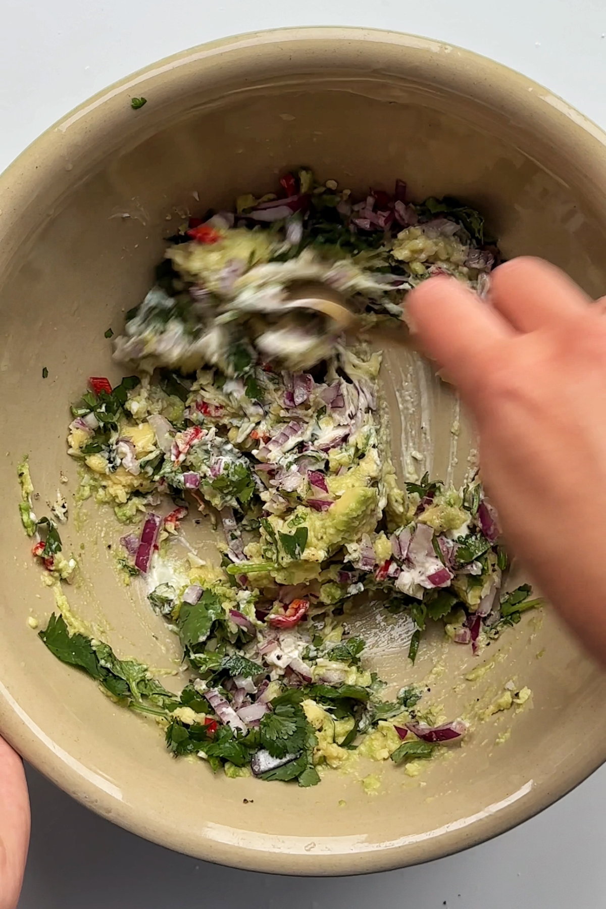 Making the arepa Reina pepiada filling in a large bowl.