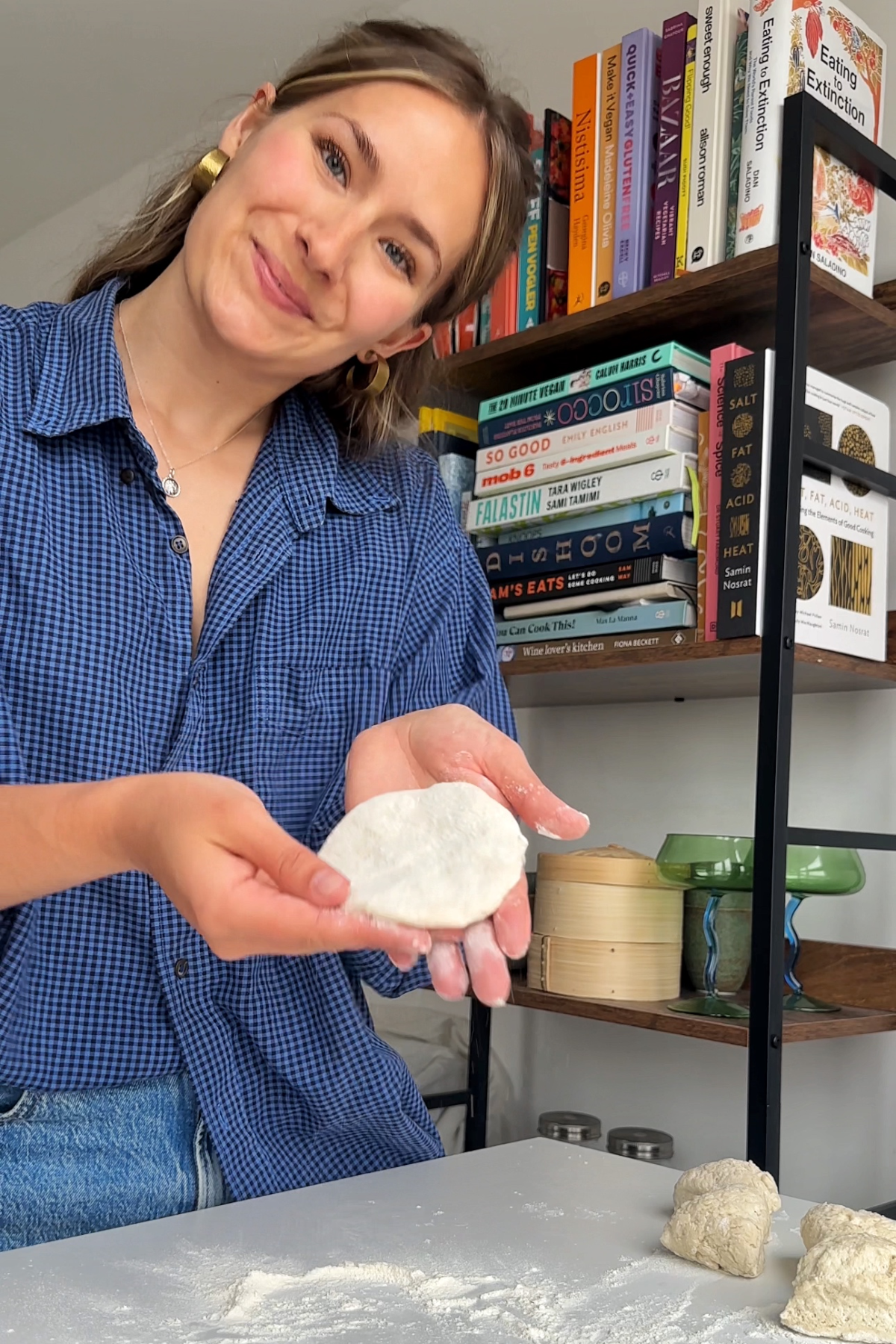 Emily Roz holding up an uncooked cheat arepa dough wrapper.