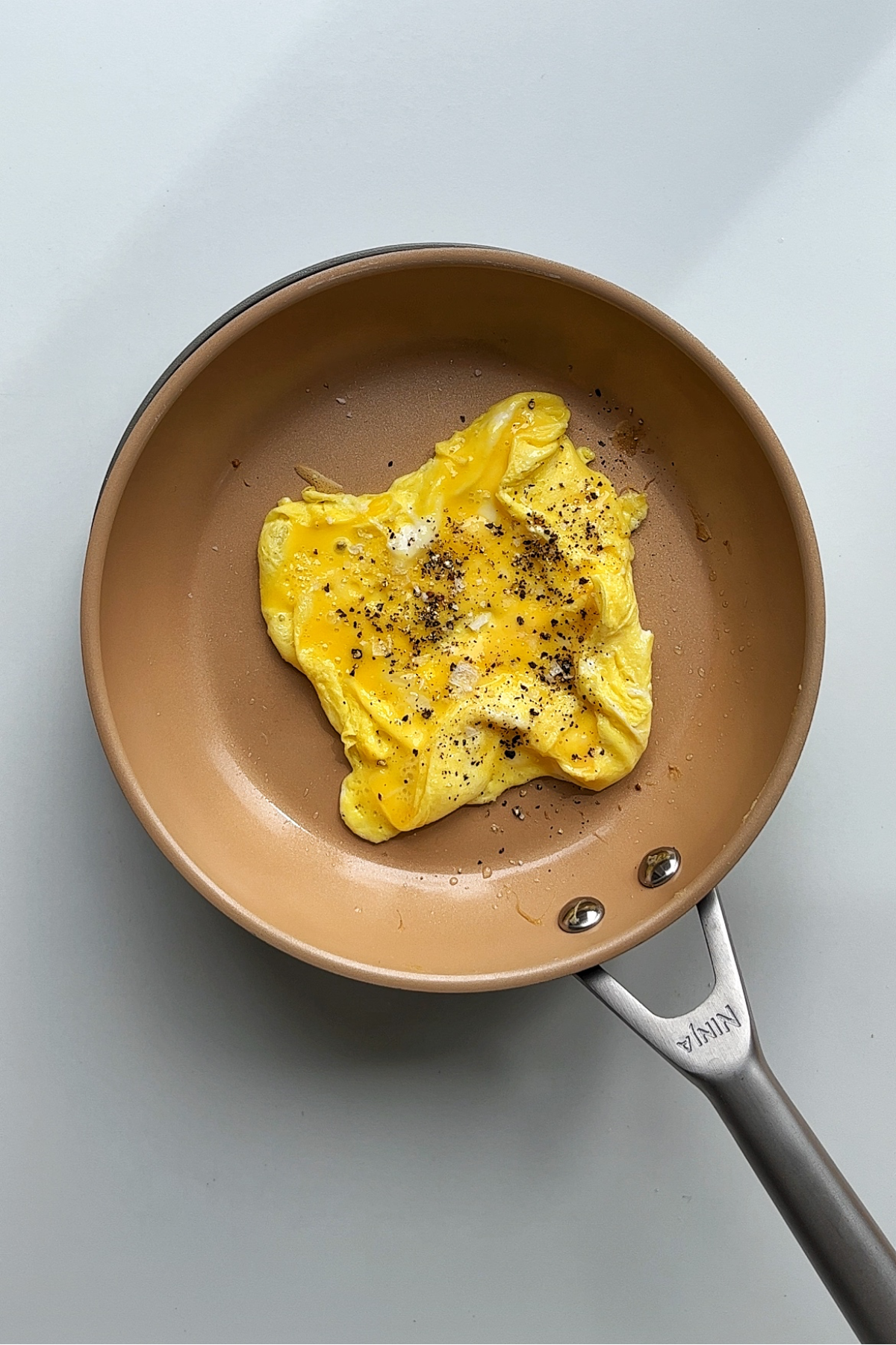 Making a square omelette in a non-stick frying pan.