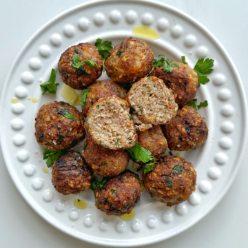 Turkey meatballs that have been air fried on a white plate.