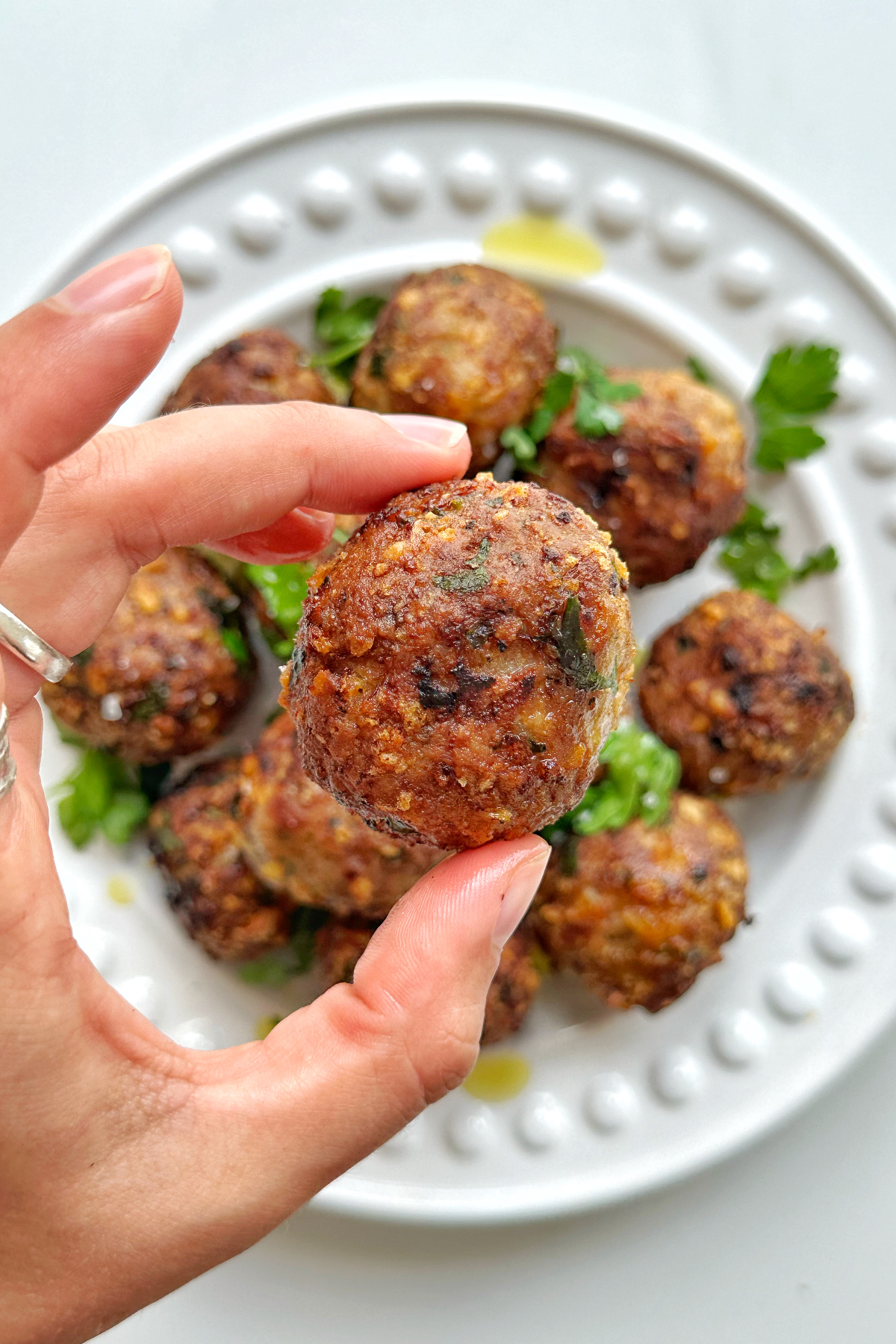 Close up image of a turkey meatball cooked in the air fryer.