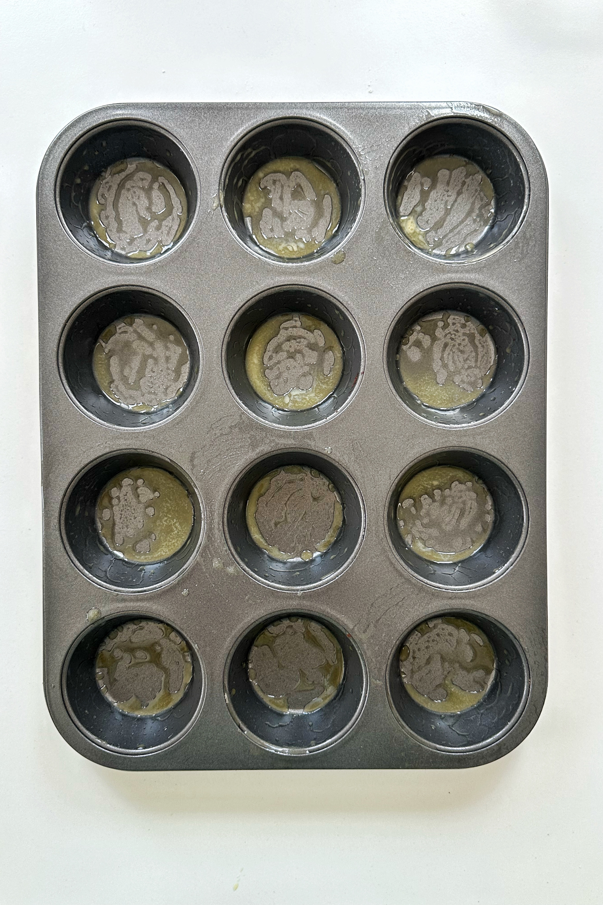 Buttered baking muffin tin.