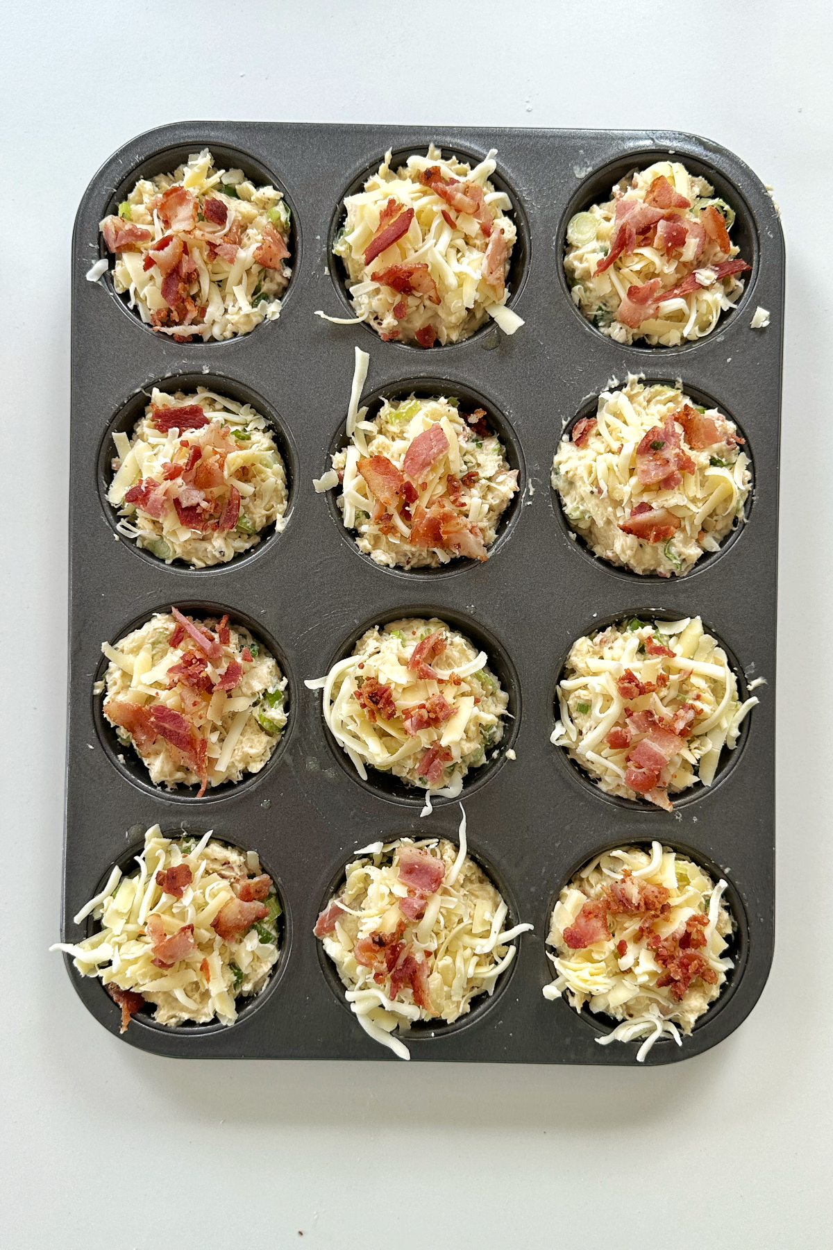 Bacon and cheese muffin before placed in the oven.